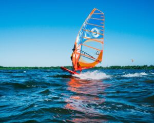 Windsurf Sailing on the Sea Under Blue Sky